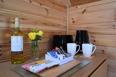 a bottle of wine on a table with a bottle of wine at Leven View Lodges - Carness in Fort William