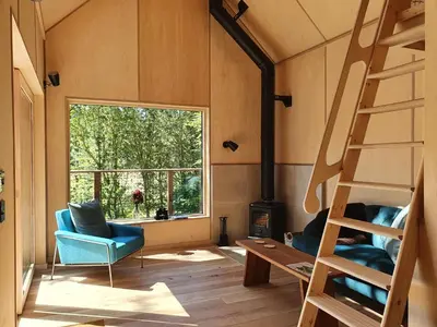 a room with a ladder and chairs and a window at Mertrick in Forest Mill