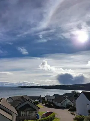 a view of a town with a lake and houses at Seaview cosy 2 bed home in Lamlash - 'Mid Drive' in Lamlash