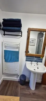 a bathroom with a white sink and a mirror at Seaview cosy 2 bed home in Lamlash - 'Mid Drive' in Lamlash