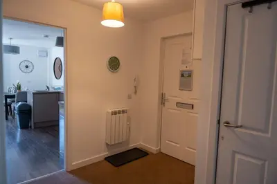 a hallway with a door leading to a room with a desk at Lagavulin Apartment in Oban