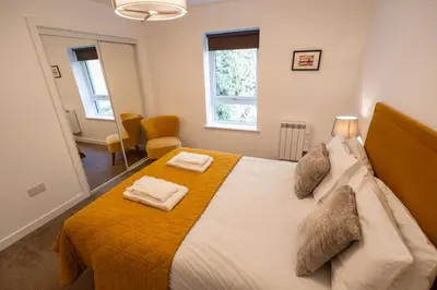 a bedroom with a bed with two pillows on it at Lagavulin Apartment in Oban