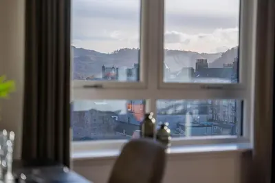 a window with a view of a city at Ledaig Apartment in Oban