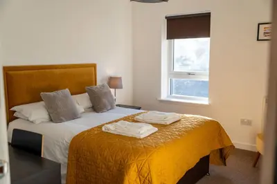 a bedroom with a bed with two towels on it at Ledaig Apartment in Oban