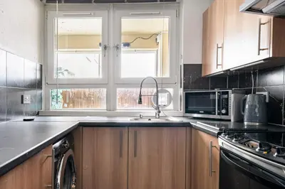 a kitchen with a sink and a window at Lovely 1-bedroom property with balcony in West end in Glasgow