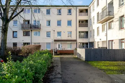 an empty sidewalk in front of an apartment building at Lovely 1-bedroom property with balcony in West end in Glasgow