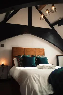 a bedroom with a large bed with green pillows at Slateford House 1770 Luxury Aparthotel by The House of Danu in Edinburgh