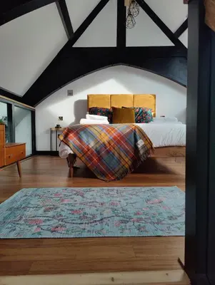 a bedroom with a bed and a rug at Slateford House 1770 Luxury Aparthotel by The House of Danu in Edinburgh