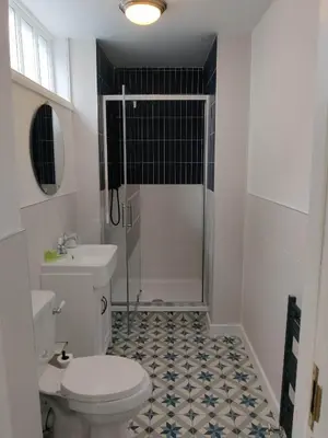 a bathroom with a white toilet and a shower at Slateford House 1770 Luxury Aparthotel by The House of Danu in Edinburgh