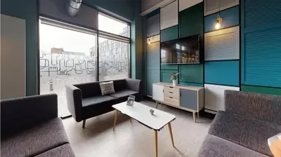 a living room with a couch and a table at Studios and Ensuite Bedrooms with Shared Kitchen at Fountainbridge in Edinburgh in Edinburgh