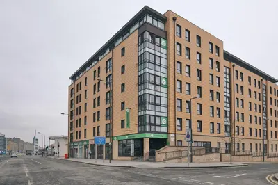 a large brick building on the corner of a street at Studios and Ensuite Bedrooms with Shared Kitchen at Fountainbridge in Edinburgh in Edinburgh