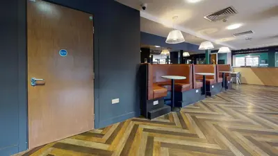 a restaurant with a bar with tables and chairs at Studios and Ensuite Bedrooms with Shared Kitchen at Fountainbridge in Edinburgh in Edinburgh