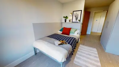 a small bedroom with a bed and a couch at Studios and Ensuite Bedrooms with Shared Kitchen at Fountainbridge in Edinburgh in Edinburgh