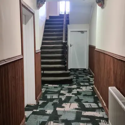 a staircase in a building with a blue and green carpet at The Beath Inn in Cowdenbeath