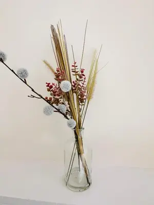a clear glass vase with some flowers in it at No.3 The Villa in Oban