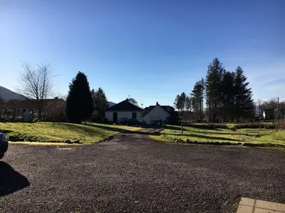 an empty road in front of a house at Snowberry Cottage No 2 in Onich