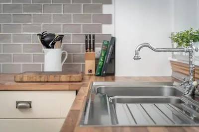 a kitchen with a sink and a counter top at Heather Cottage, 2 bedroom in Comrie in Comrie