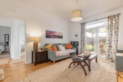 a living room with a couch and a table at Heather Cottage, 2 bedroom in Comrie in Comrie