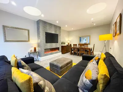 a living room with a couch and a fireplace at 2Bed, Private Garden & Fireplace, Near Water of Leith in Edinburgh