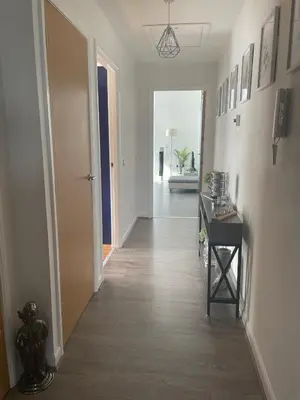 a hallway with a hallway leading to a room at THE PAISLEY PENTHOUSE - ABBEY VIEW in Paisley