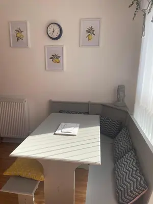 a white table in a room with a clock on the wall at THE PAISLEY PENTHOUSE - ABBEY VIEW in Paisley