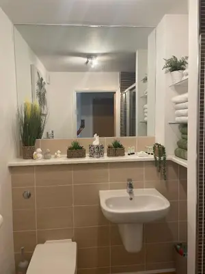 a bathroom with a sink and a mirror at THE PAISLEY PENTHOUSE - ABBEY VIEW in Paisley