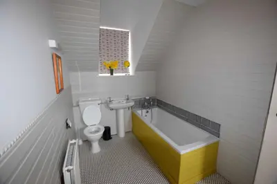 a bathroom with a toilet and a tub and a sink at Rural Farmhouse on Kintyre, West Coast hidden gem in Kildalloig