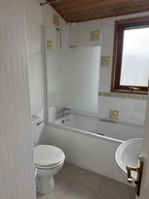 a bathroom with a toilet and a tub and a sink at Walled Garden Lodges Loch Lomond in Balloch