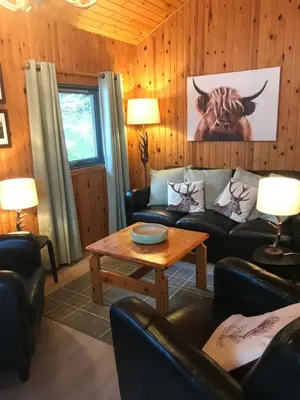 a living room with a couch and a table at Gulls Island in Morenish