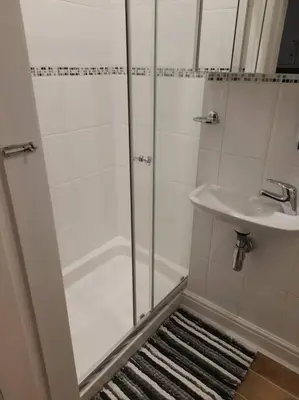 a bathroom with a shower and a sink at Modern flat near city centre. in Edinburgh