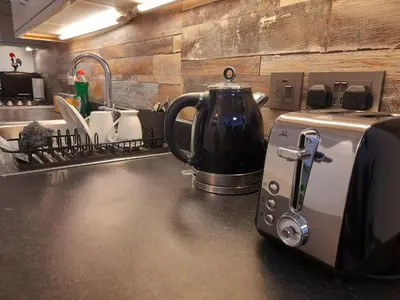 a kitchen counter with a coffee maker and a toaster at Modern flat near city centre. in Edinburgh