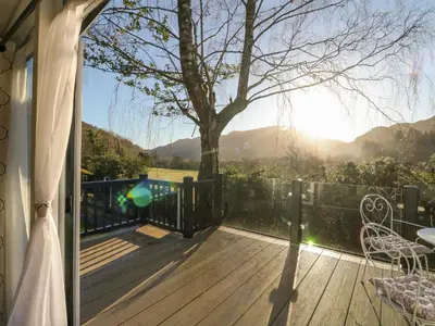 a deck with a view of a tree at Hollybirch in Crieff