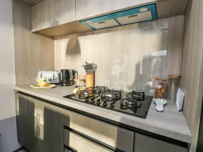 a kitchen with a stove top oven in a kitchen at Hollybirch in Crieff