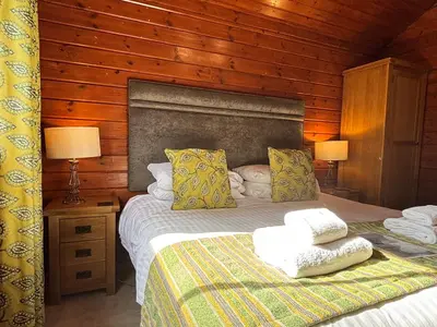 a bedroom with a bed with two towels on it at Lady Galloway 27 with Hot Tub in Newton Stewart