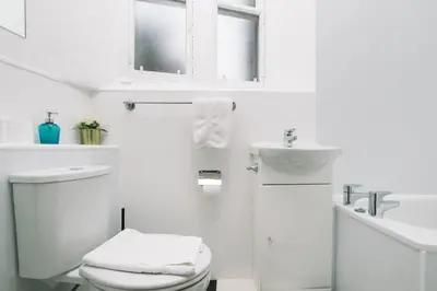a white bathroom with a toilet and a sink at charm & character on historic Rose Street in Edinburgh