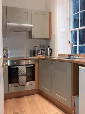 a kitchen with a stainless steel oven and a sink at charm & character on historic Rose Street in Edinburgh