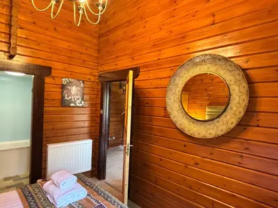 a room with a wooden wall with a mirror at Lady Galloway 29 with Hot Tub in Newton Stewart