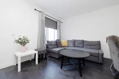 a living room with a couch and a table at Stylish 3BR Home with Garden & Free Parking - Near O2 Academy & City Centre in Glasgow