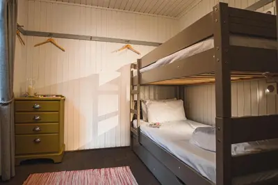 a bedroom with a bunk bed and a dresser at Crieff Hydro Self Catering in Crieff