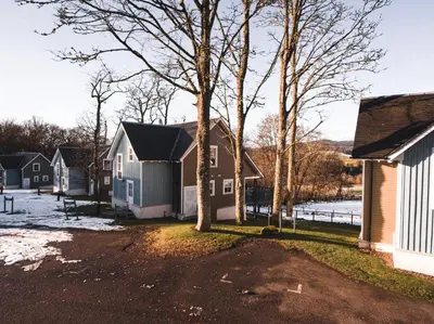 a group of houses and trees in a yard at Crieff Hydro Self Catering in Crieff