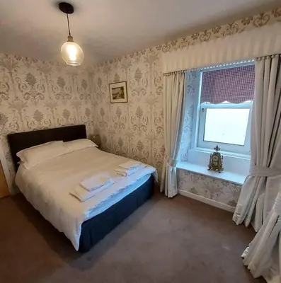 a bedroom with a bed and a window at Lovely 1 Bed house in Largs, North Ayrshire in Largs
