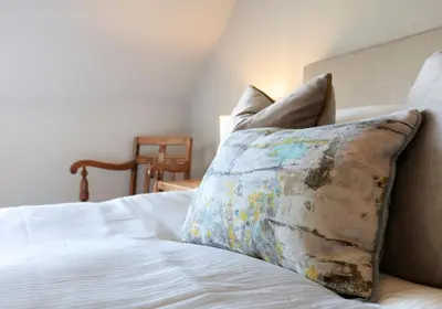 a bed with a pillow on top of it at The Botanics Residence in Edinburgh
