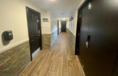 a hallway with wooden floors in a building at The Beach House Loch Lomond in Luss