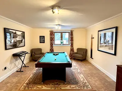 a living room with a pool table in it at Keepers Lodge with Hot Tub in Forgandenny