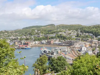a view of a town on the water with a harbor at The Coach House in Oban