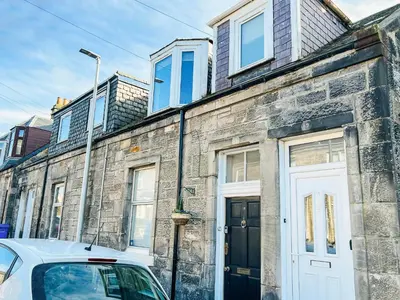 a white car parked in front of a brick building at The Wee Pad - Uk42918 in Dunfermline