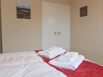 a pile of towels sitting on top of a bed at The Shieling in Biggar