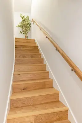 a stairwell with wooden stairs and a potted plant at Dragon Suites - Yukina Suite - 2 bed city centre house with garden in Edinburgh