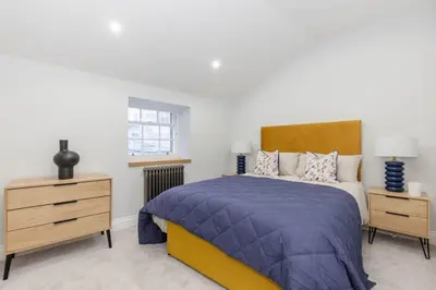 a bedroom with a bed and two night stands at Dragon Suites - Yukina Suite - 2 bed city centre house with garden in Edinburgh