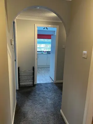 a hallway with an archway leading to a kitchen at 5 minutes to Glasgow airport in Paisley